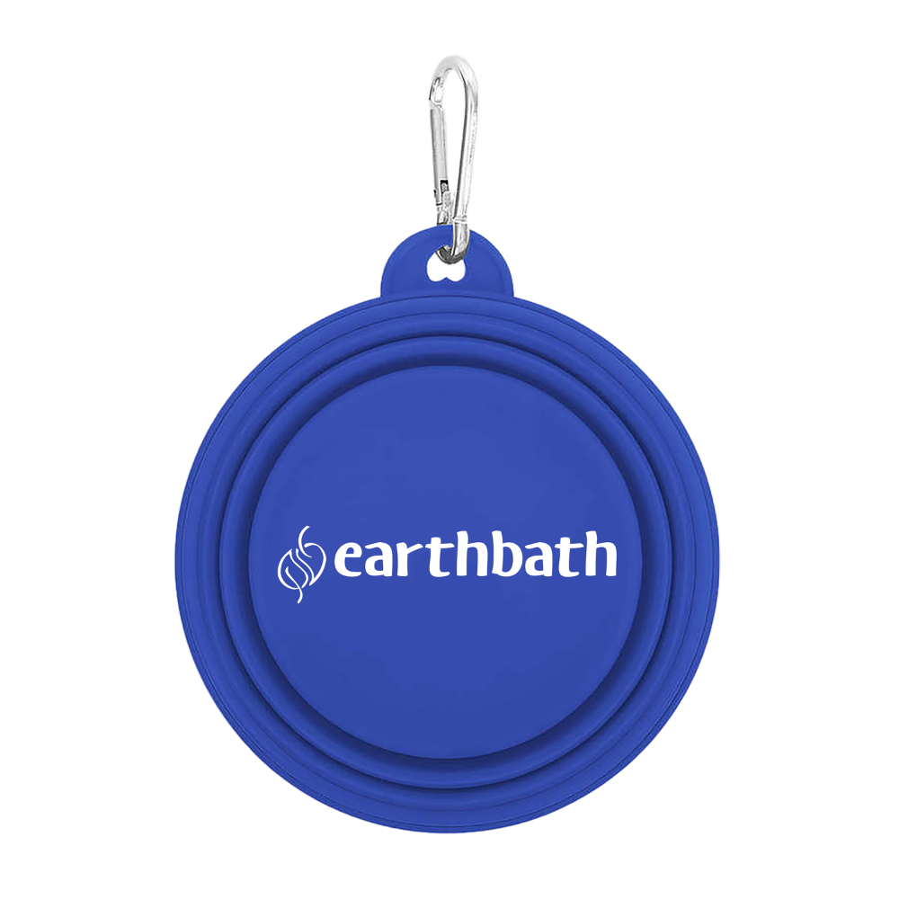 A blue collapsible silicone pet bowl with a carabiner attached to it, branded with 'earthbath'.