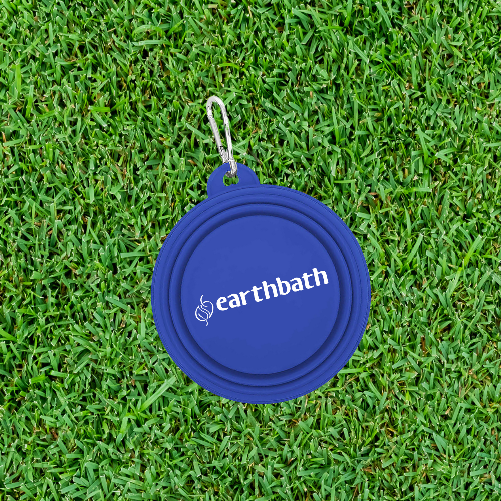 Blue pet bowl lid with 'earthbath' logo on grass
