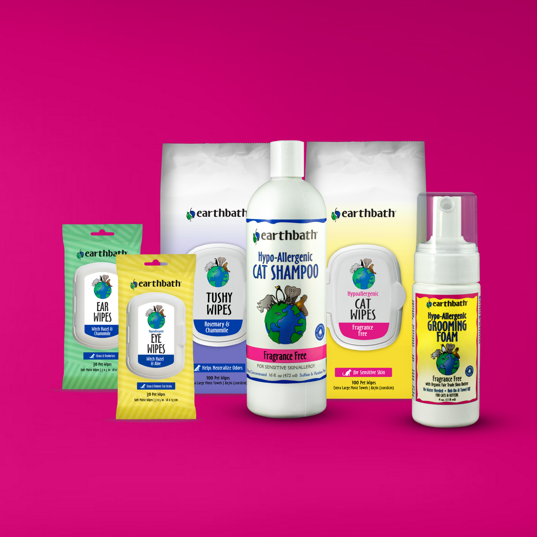 A set of earthbath branded pet grooming products for cats on a pink background